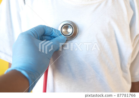 Doctor using a stethoscope checking child body, close up 87781766