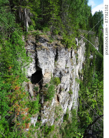 One of the caves in the mountain of the Usvinskiye Pillars massif. Perm region. Russia One of the caves in the mountain of the Usvinskiye Pillars massif. Perm region. Russia 87782102