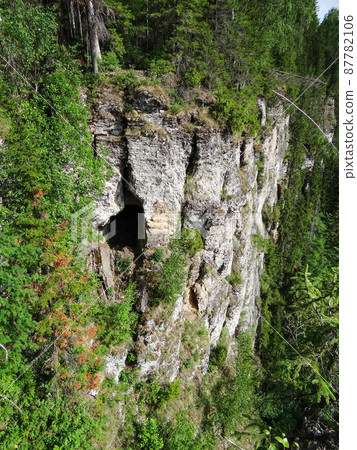 One of the caves in the mountain of the Usvinskiye Pillars massif. Perm region. Russia One of the caves in the mountain of the Usvinskiye Pillars massif. Perm region. Russia 87782106