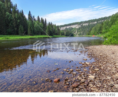 The picturesque river Usva with a view of the Usvinskiye Pillars rock massif. Perm region. Russia The picturesque river Usva with a view of the Usvinskiye Pillars rock massif. Perm region. Russia 87782450