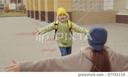 little girl schoolgirl with backpack runs hug her mother, kid rejoice over lessons, happy family, school bag behind back cheerful laughing child, baby hurries her mother her arms, jogging school yard little girl schoolgirl with backpack runs hug her mother, kid rejoice over lessons, happy family, school bag behind back cheerful laughing child, baby hurries her mother her arms, jogging school yard 87783119
