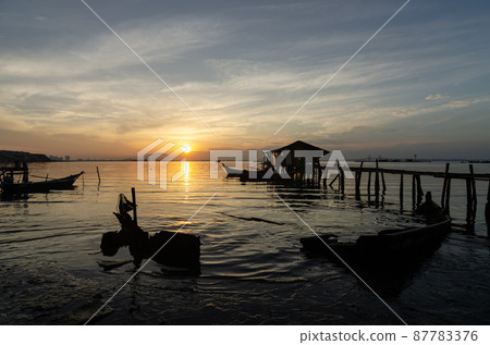 Fisherman wooden hut and sink boat near sea coastal 87783376