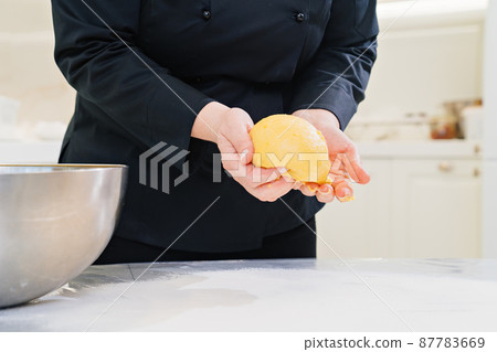 women's hands knead dough. homemade baking and cooking school. women's hands knead dough. homemade baking and cooking school. 87783669