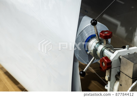 machine with roll of newly produced transparent plastic film 87784412