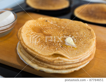 cooking traditional pancakes from wheat flour in the kitchen 87784651