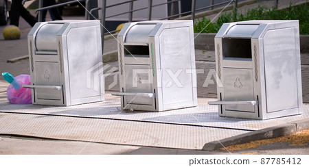 Stainless steel garbage cans for separate disposal of recycle trash on city street 87785412