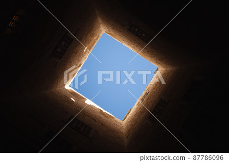 Square light window in dark tower interior Square light window in dark tower interior 87786096