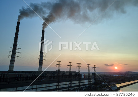 Aerial view of coal power plant high pipes with black smokestack polluting atmosphere. Electricity production with fossil fuel concept Aerial view of coal power plant high pipes with black smokestack polluting atmosphere. Electricity production with fossil fuel concept 87786240
