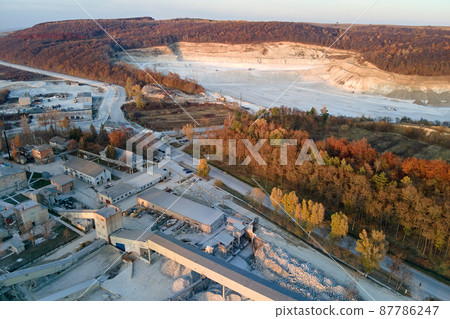 Aerial view of cargo train loaded with crushed sandstone materials at mine factory. Railway transportation of open pit mining ore 87786247