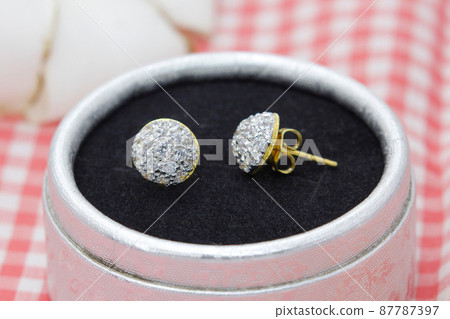 Beautiful golden earrings decorated with diamond display in jewelry box 87787397