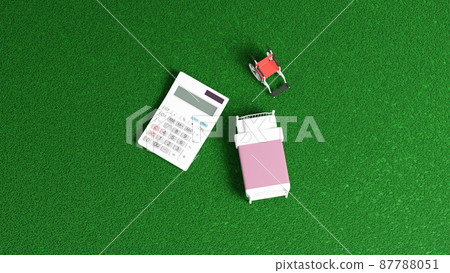 3D rendered illustration of a miniature bed and wheelchair placed on a flat surface, and a calculator 87788051