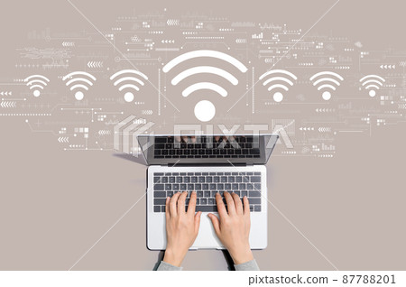 Wifi theme with person using laptop Wifi theme with person using laptop 87788201