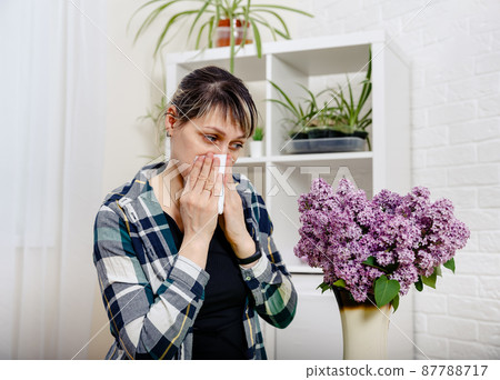 A sick woman having runny nose, sore eyes. Spring allergy concept. 87788717