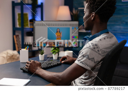African american photographer editing image using pictures retouching 87789217