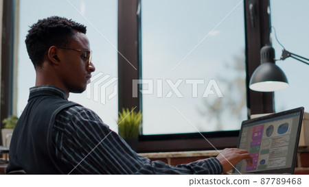 Business man using laptop to plan successful investment Business man using laptop to plan successful investment 87789468