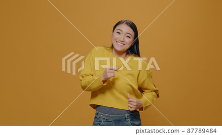 Cheerful person doing celebratory dance moves on camera Cheerful person doing celebratory dance moves on camera 87789484