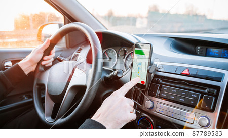 Gps navigation map system. Global positioning system on smartphone screen in auto car on travel road. GPS device satellite system technology. 87789583