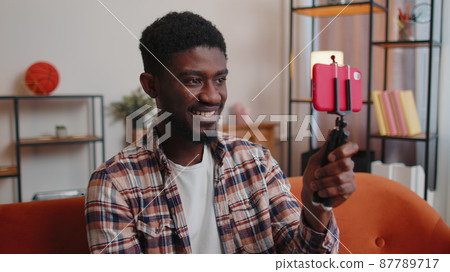 Man blogger influencer taking selfie on smartphone, make virtual social media video online at home 87789717