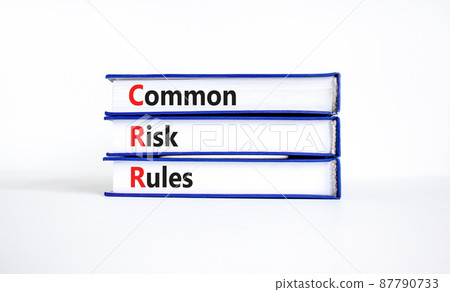 CRR common risk rules symbol. Concept words CRR common risk rules on books on a beautiful white table, white background. Business and CRR common risk rules concept. Copy space. CRR common risk rules symbol. Concept words CRR common risk rules on books on a beautiful white table, white background. Business and CRR common risk rules concept. Copy space. 87790733