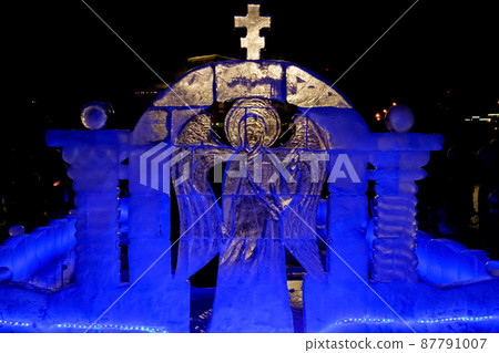 Ice sculpture. Angel with wings. The Feast of the Epiphany. People bathe in the ice-hole. 87791007
