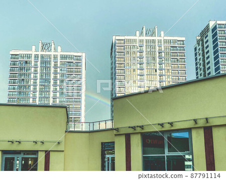 a new area of the city with high glass houses. new buildings with glass windows and doors. next to a shopping center painted yellow a new area of the city with high glass houses. new buildings with glass windows and doors. next to a shopping center painted yellow 87791114