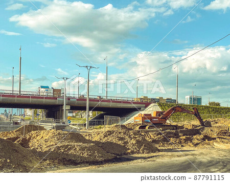 construction of a new area of the city. construction ditch, laying of cables and underground communications. construction of a new overpass in a large microdistrict construction of a new area of the city. construction ditch, laying of cables and underground communications. construction of a new overpass in a large microdistrict 87791115