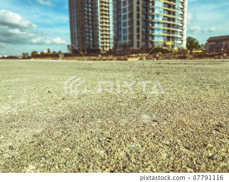 construction of a new microdistrict in the city center. construction of high concrete houses. beige sand and stone pavement construction of a new microdistrict in the city center. construction of high concrete houses. beige sand and stone pavement 87791116