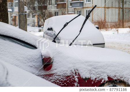 Cars under the snow with the wipers raised Cars under the snow with the wipers raised 87791186