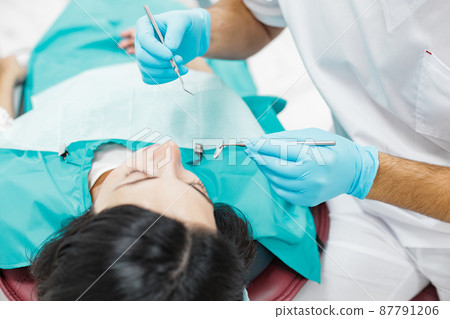 Cute young girl is being examined by the dentist 87791206