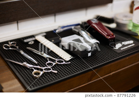 Shearing tools are laid out on a wooden table Shearing tools are laid out on a wooden table 87791226