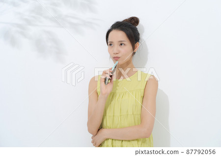 Woman with smartphone white background 87792056