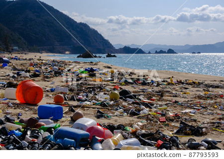 Marine debris washed ashore on a beautiful crystal beach Marine debris washed ashore on a beautiful crystal beach 87793593