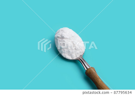 Baking soda on blue background. 87795634