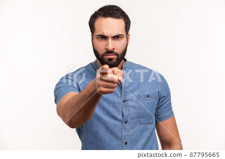 Serious bossy bearded man pointing finger at camera choosing you, scolding and forcing to move on. Indoor studio shot isolated on white background 87795665