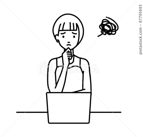 A woman in a dress sitting at a desk and opening her PC A woman in a dress sitting at a desk and opening her PC 87795693