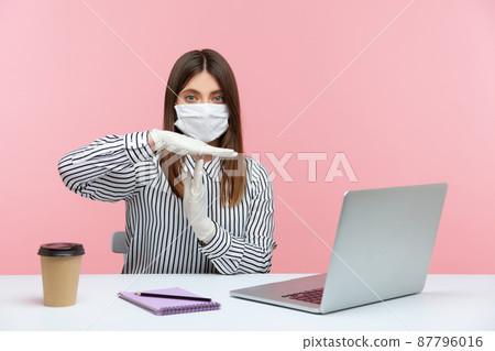 Quarantine break. Businesswoman sitting safe healthy with hygienic face mask and protective gloves, showing time out gesture, stop enough sign. Working in self-isolation, coronavirus outbreak. indoor 87796016