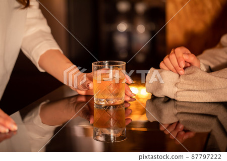 Woman talking at the bar counter BAR 87797222