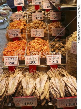 Dried shrimp (in the center of the back) and dried squid (in the foreground) sold at a dry food store in the west of Des Voeux Road, Hong Kong. 87797689