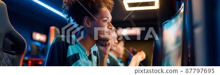 Skillful woman gamer practicing in gaming arena in internet club Skillful woman gamer practicing in gaming arena in internet club 87797695