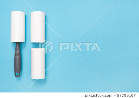 Sticky Hair Removal Roller. Copy space. Place for text. Lint Roller Dog, Cat, Animal, Hair Remover. Pet Fur, Fuzz. Blue background. Flat lay. Top view. Sticky Hair Removal Roller. Copy space. Place for text. Lint Roller Dog, Cat, Animal, Hair Remover. Pet Fur, Fuzz. Blue background. Flat lay. Top view. 87799107