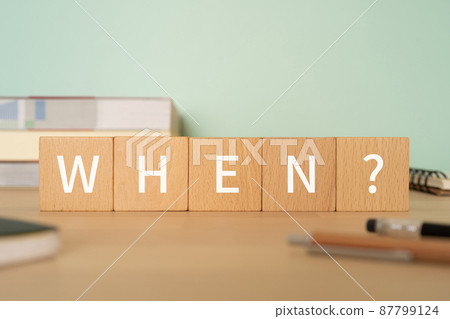 Blocks, books, notebooks, pens with "WHEN?" Written on them Blocks, books, notebooks, pens with "WHEN?" Written on them 87799124