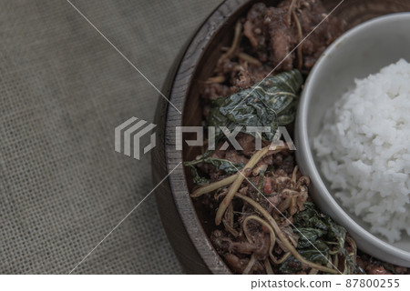 Thai Spicy food, Spicy Stir Fried Deep Fish Fillet with Herbs vegetables served with steamed rice in wooden bowl 87800255