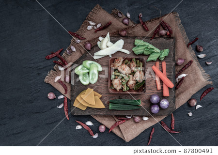 Thai food, Stir Fried fish ball with Red Curry Paste and long bean with the ingredient and fresh vegetables on wood background. 87800491