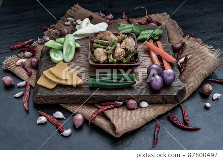 Thai food, Stir Fried fish ball with Red Curry Paste and long bean with the ingredient and fresh vegetables on wood background. Thai food, Stir Fried fish ball with Red Curry Paste and long bean with the ingredient and fresh vegetables on wood background. 87800492