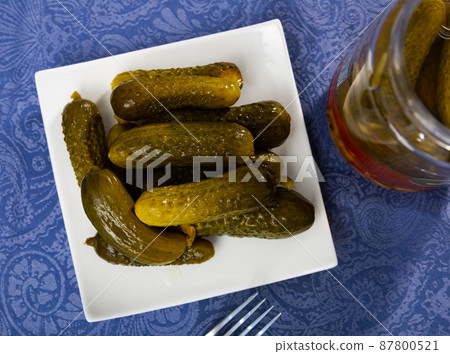 Pickled cucumbers on a ceramic plate Pickled cucumbers on a ceramic plate 87800521