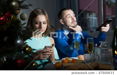 Couple having boring dinner Couple having boring dinner 87800633