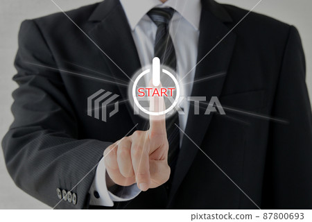 Businessman pushing the start button Businessman pushing the start button 87800693