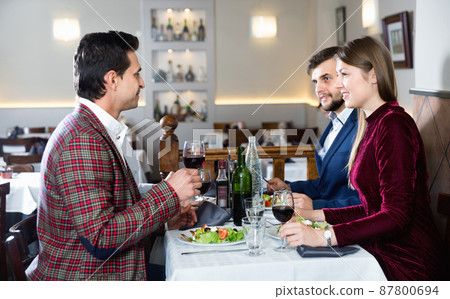 Friendly meeting over dinner with wine in restaurant Friendly meeting over dinner with wine in restaurant 87800694