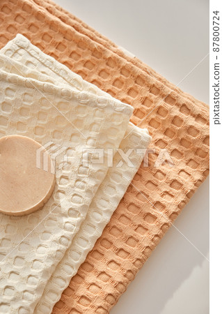 Handmade natural olive soap lies on a natural muslin towel. Composition in beige. 87800724