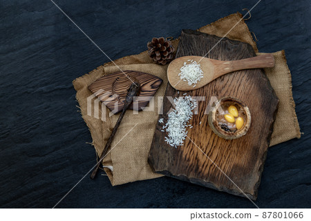 Sticky Rice Cooked with Coconut milk (Khao lam) or Glutinous rice roasted in bamboo joints on wooden, Thai dessert concept. 87801066